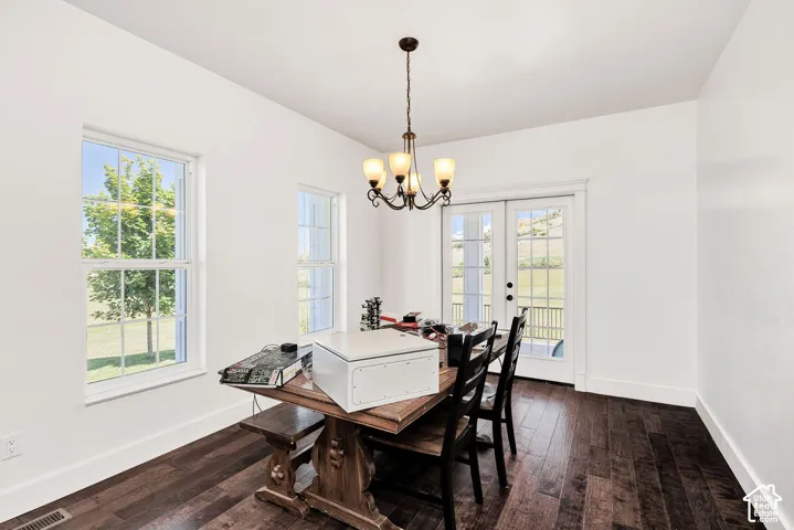 Bright room featuring dark wood-finish flooring, white walls, and white trim