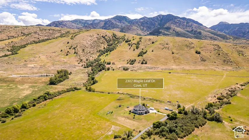 Expansive property featuring a single-family residence, substantial land, and mountainous terrain