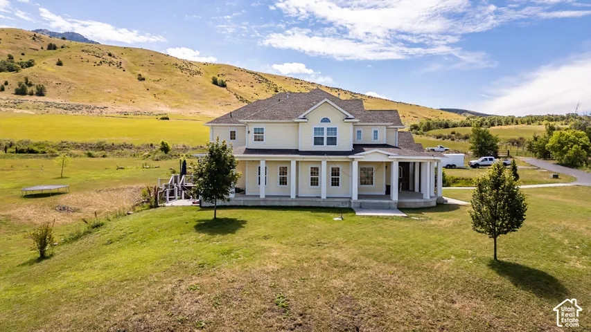 Expansive property featuring a two-story residence with a covered front porch and multiple windows