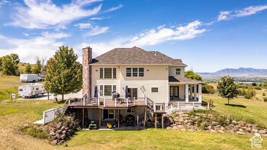 Cream-colored siding exterior with a multi-level deck and covered porch