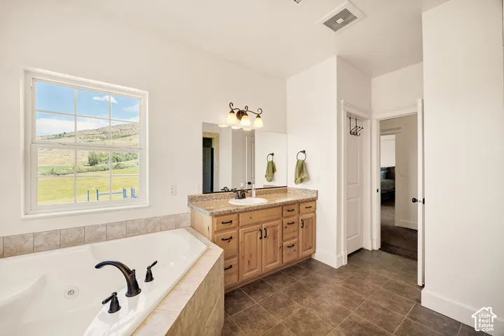 Built-in corner soaking tub with dark bronze fixtures