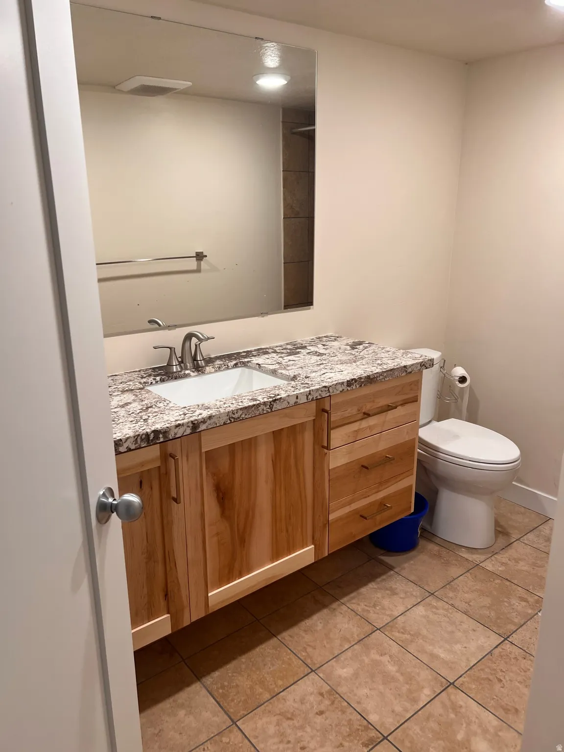 Bathroom featuring vanity, light tile patterned floors, and recessed lighting