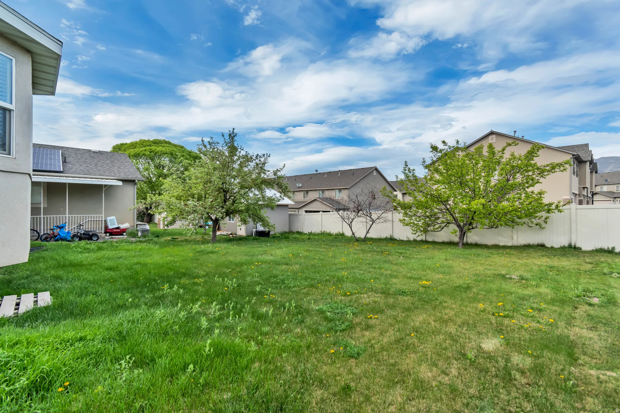Fenced yard featuring a residential view