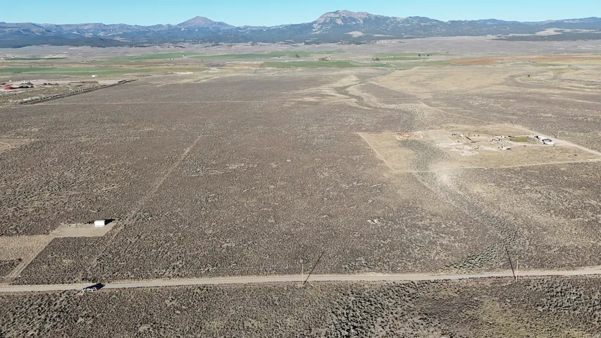 Aerial view of sparsely populated area featuring a mountain backdrop