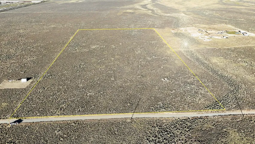 Aerial view of sparsely populated area with property parcel outlined