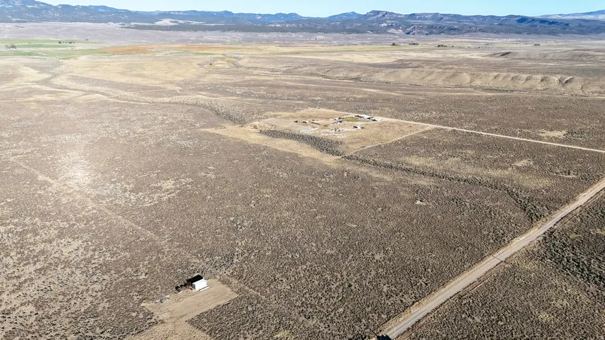 Aerial view of sparsely populated area featuring a mountain backdrop