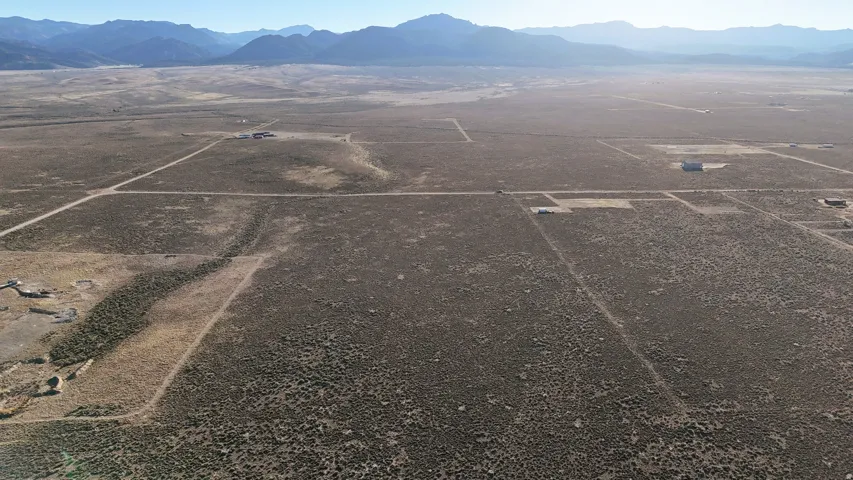 Aerial view of sparsely populated area featuring a mountainous background