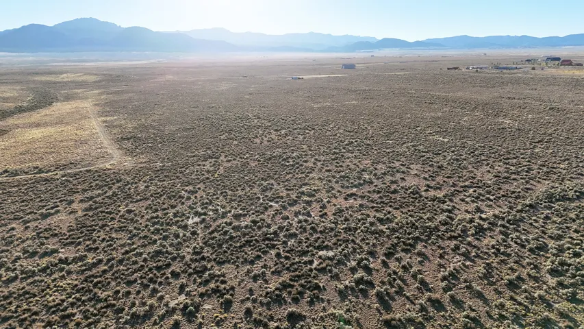 Aerial view of sparsely populated area with a mountainous background and a desert landscape