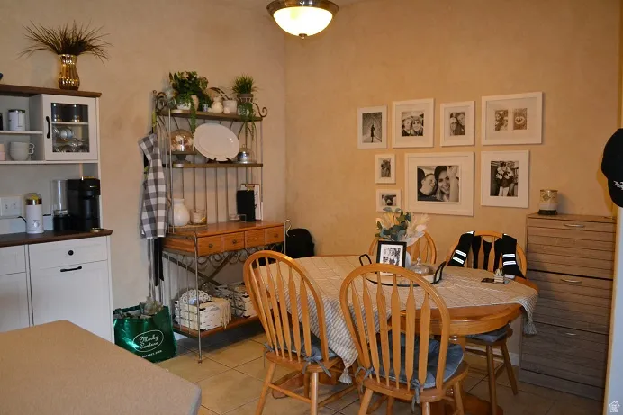 Dining area with light tile patterned flooring