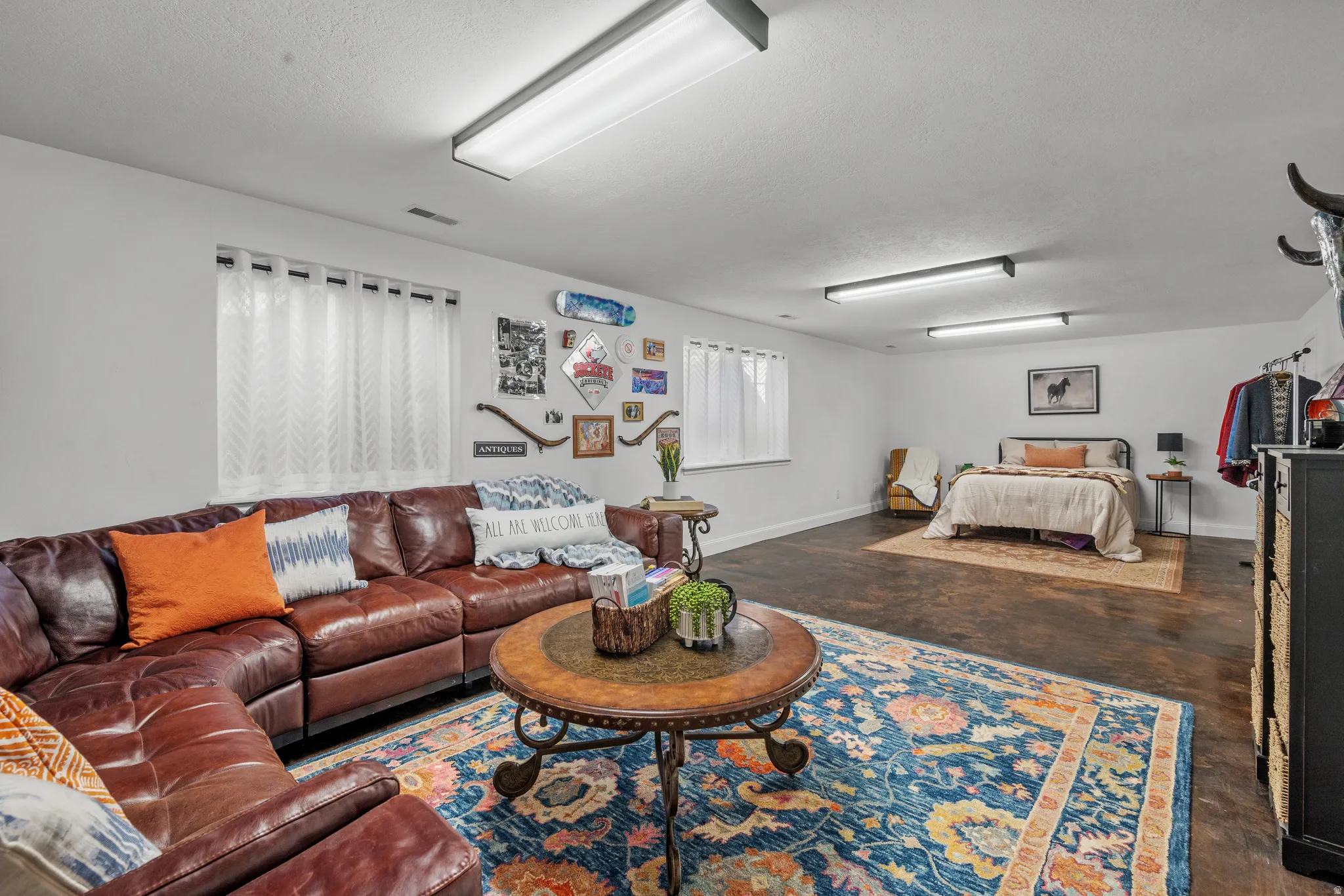 basement family room with concrete floors