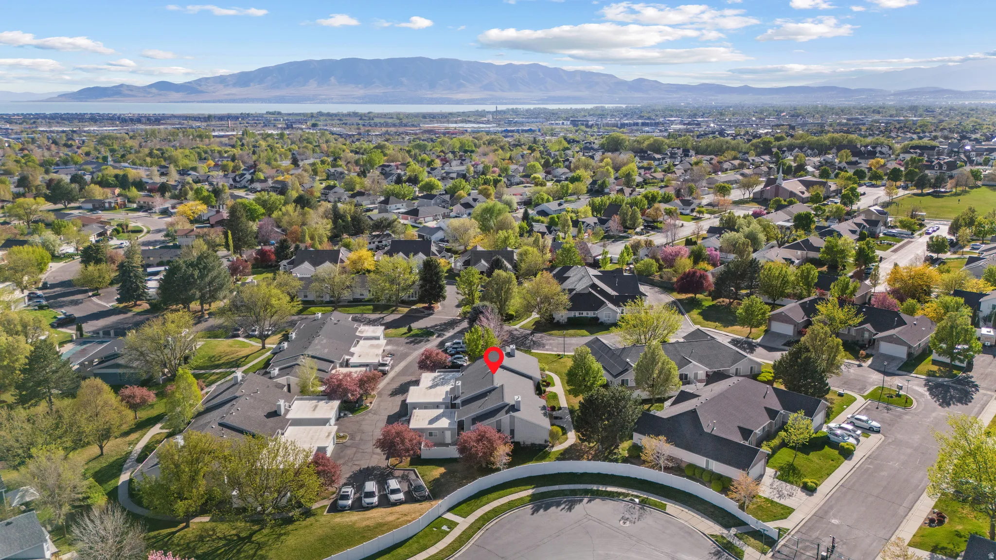 Aerial perspective of suburban area featuring a mountain backdrop