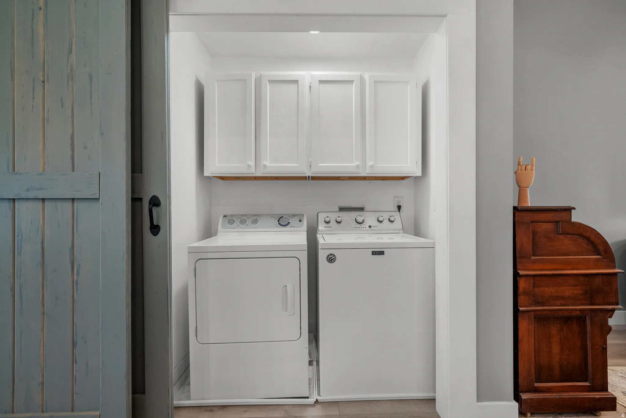 Laundry room with cabinet space and washer and dryer - hidden behind the large barn doors.