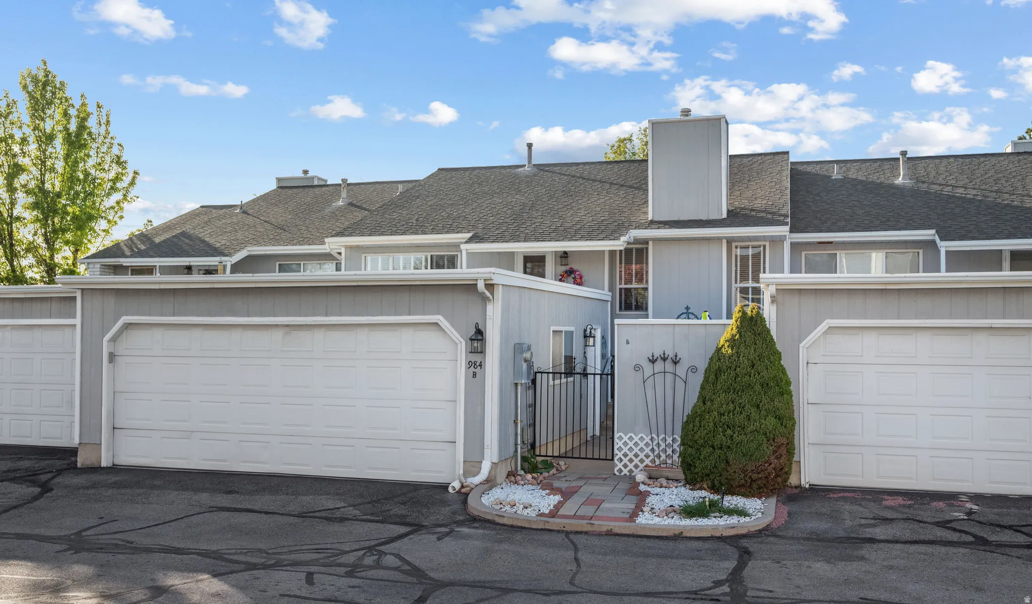 Rear view of property showing garage and back patio entrance