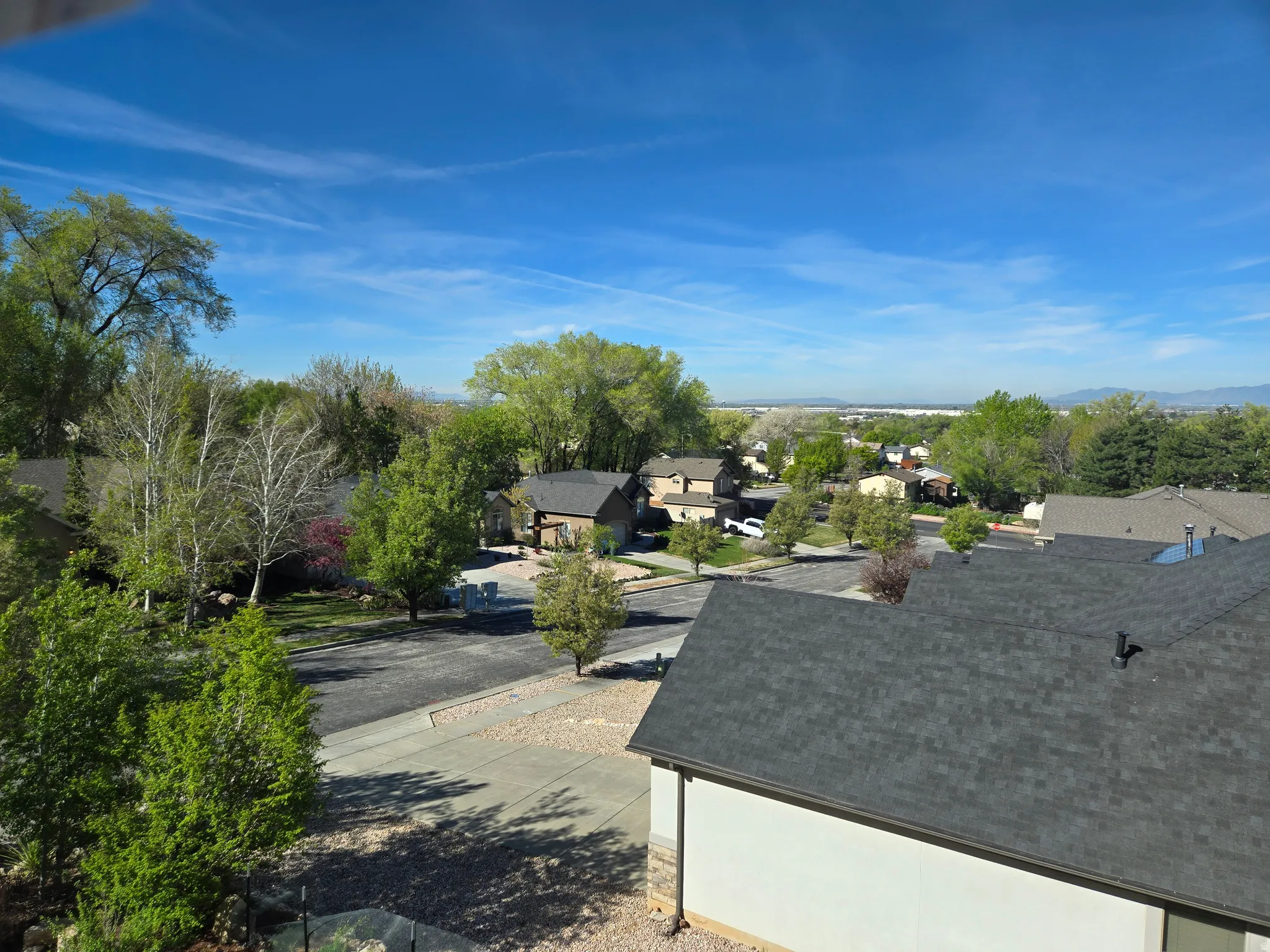 View of street featuring a residential view, curbs, and view of scattered trees