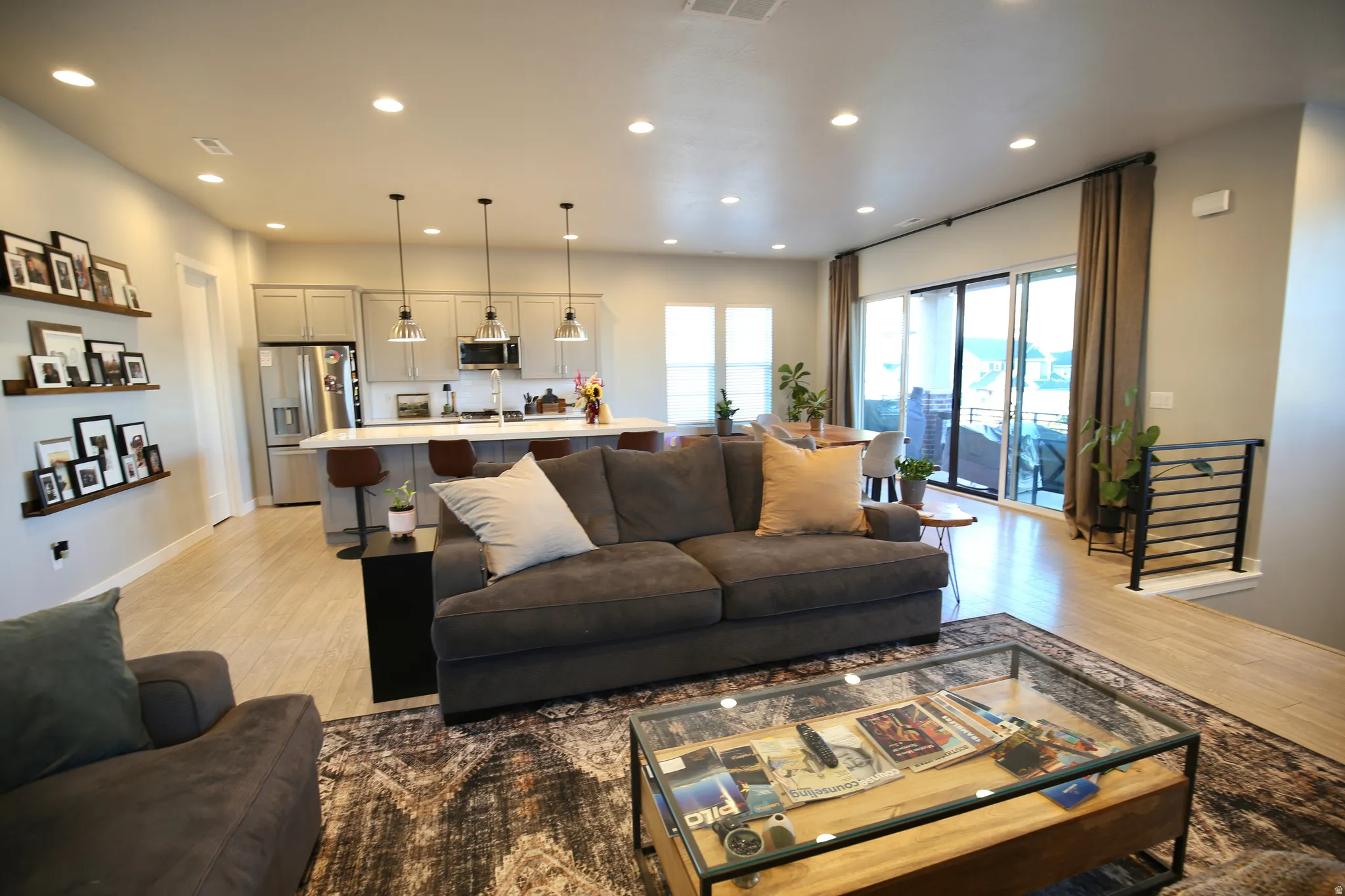 Living room with recessed lighting and light wood-type flooring