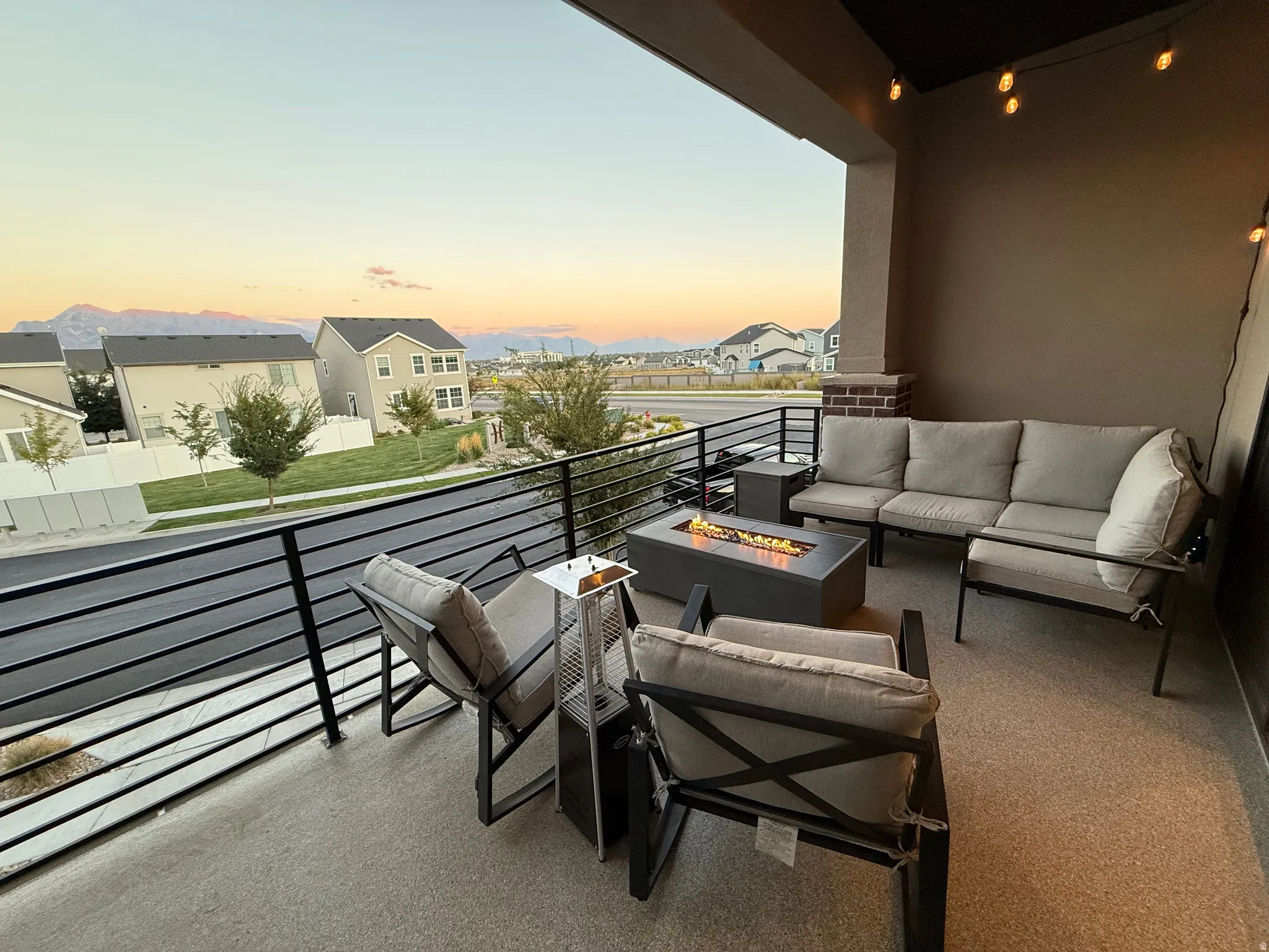 Balcony with an outdoor living space with a fire pit and a residential view