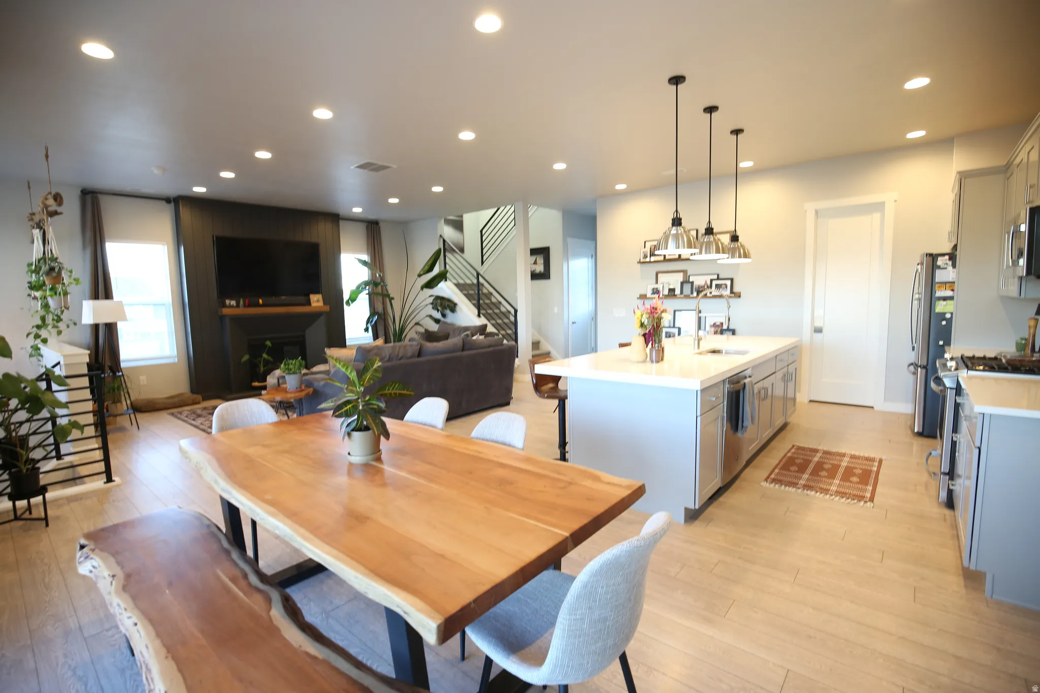 Dining area featuring light wood-style floors, recessed lighting, and a fireplace