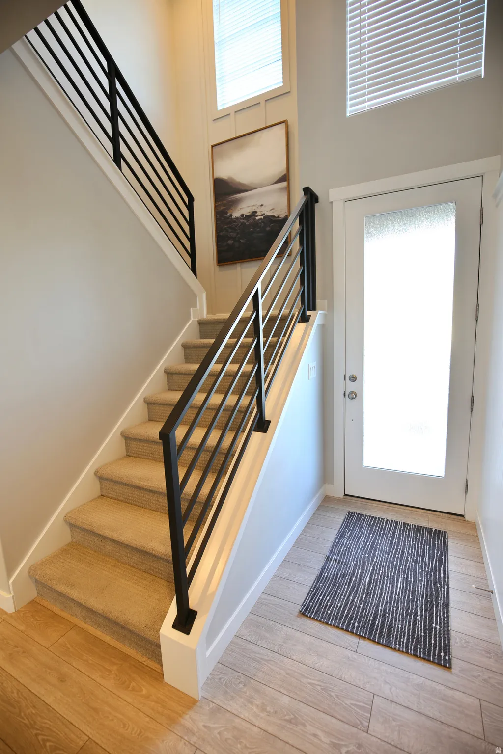 Foyer entrance with light wood finished floors