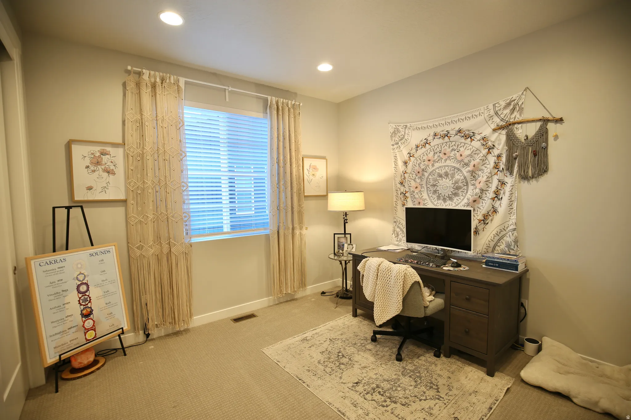 Office space with light carpet and recessed lighting