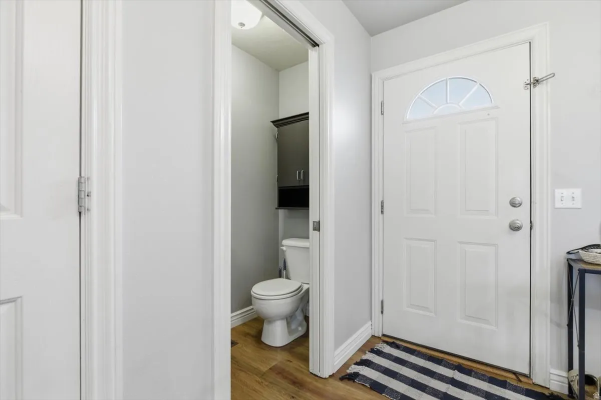 Foyer with light wood-type flooring and baseboards