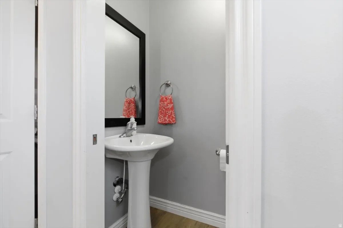 Bathroom featuring baseboards and light wood-style floors