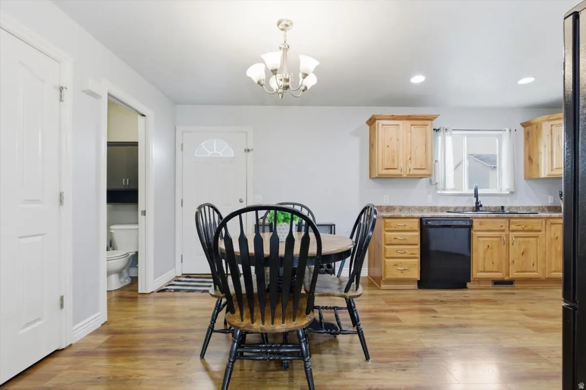 Dining space with a chandelier and light wood finished floors