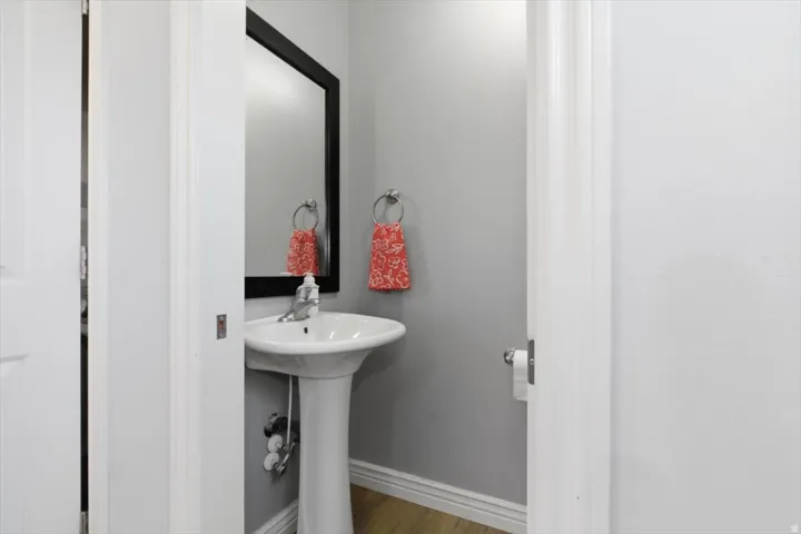 Bathroom featuring baseboards and light wood-style floors
