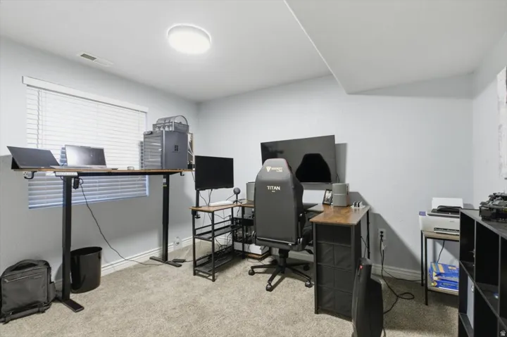 Office area with light colored carpet and baseboards