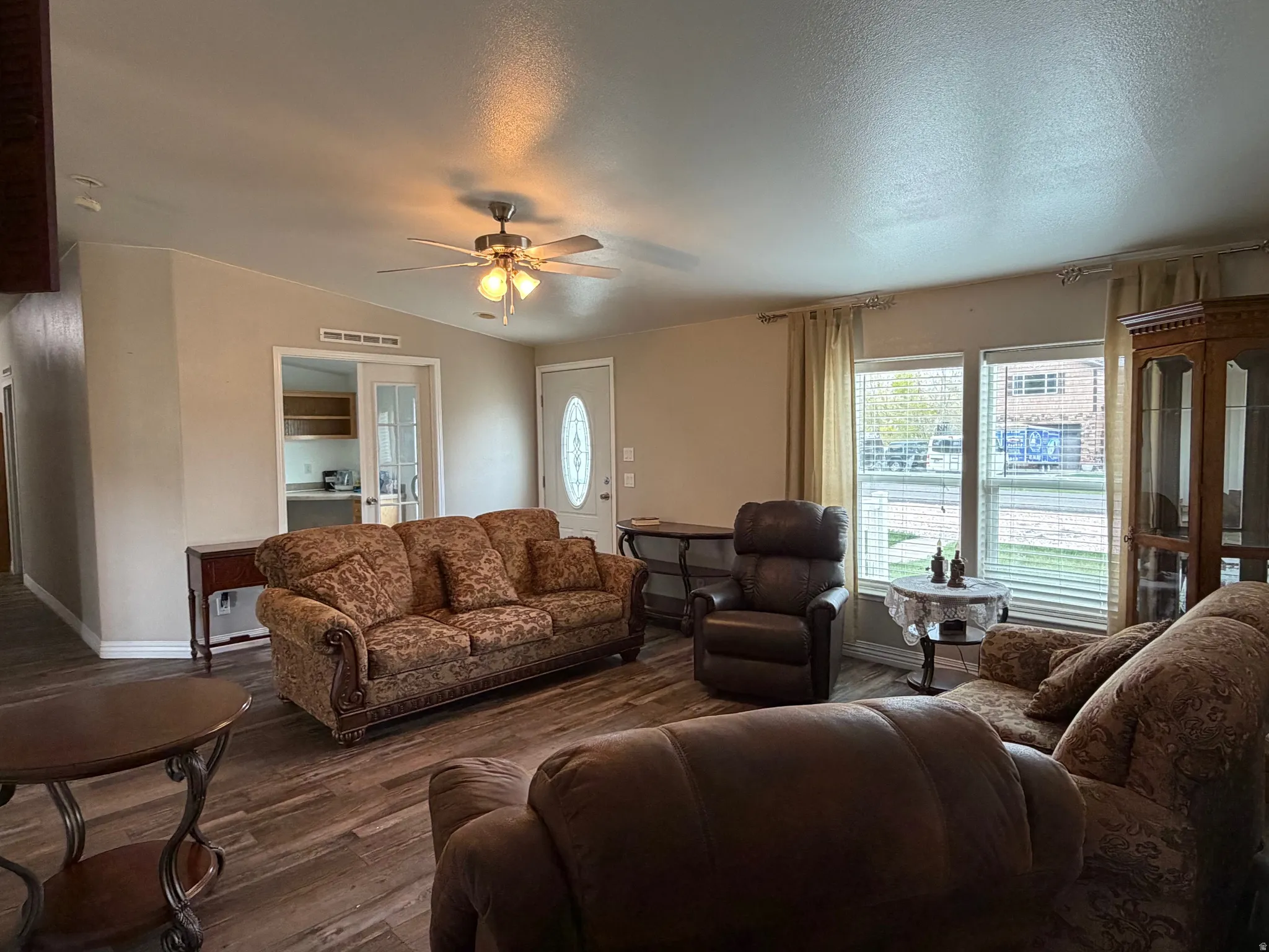 Living area featuring wood finished floors and a ceiling fan