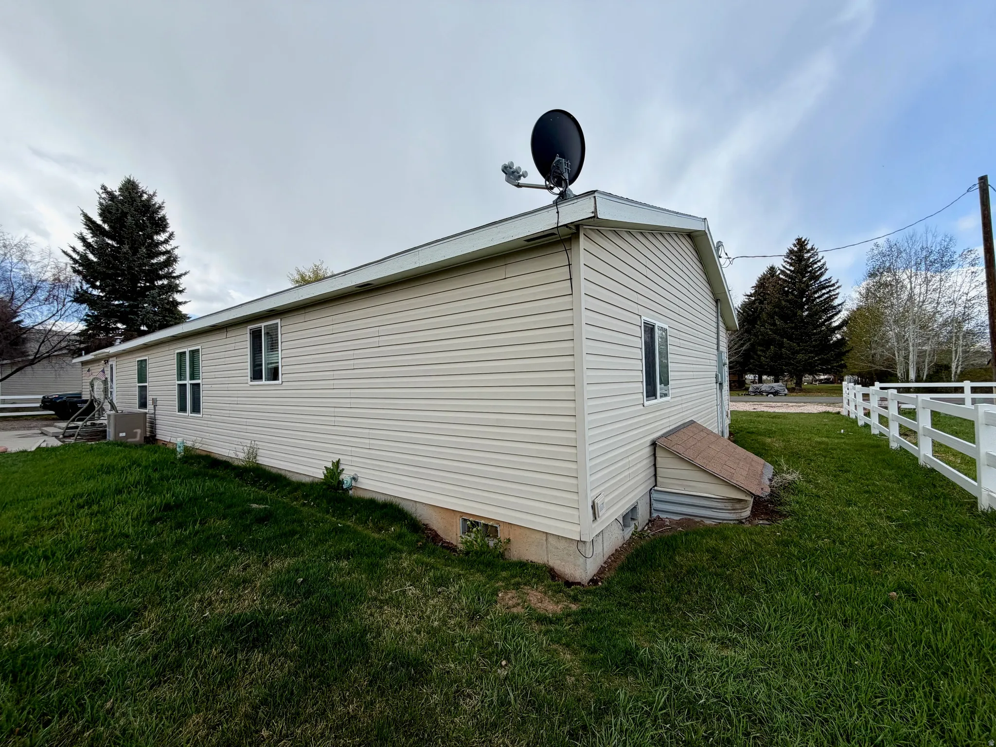 View of side of property with crawl space and a central air condition unit