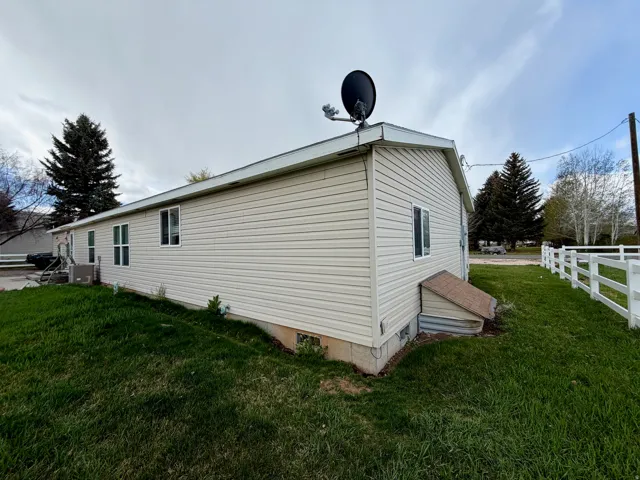 View of side of property with crawl space and a central air condition unit