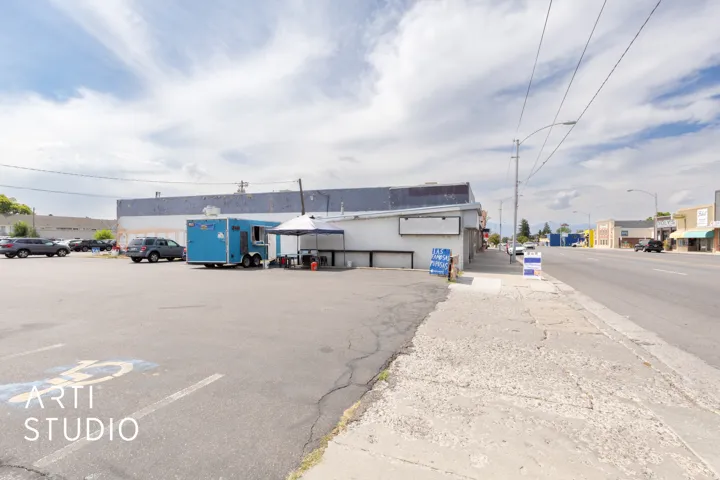 View of commercial property with uncovered parking