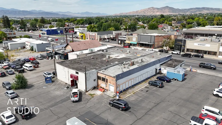 Drone / aerial view of a commercial area and a mountain backdrop