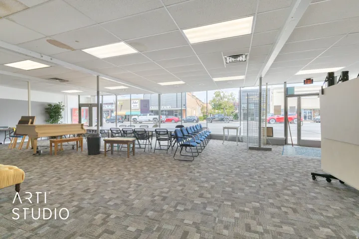 Common area featuring a paneled ceiling and floor to ceiling windows
