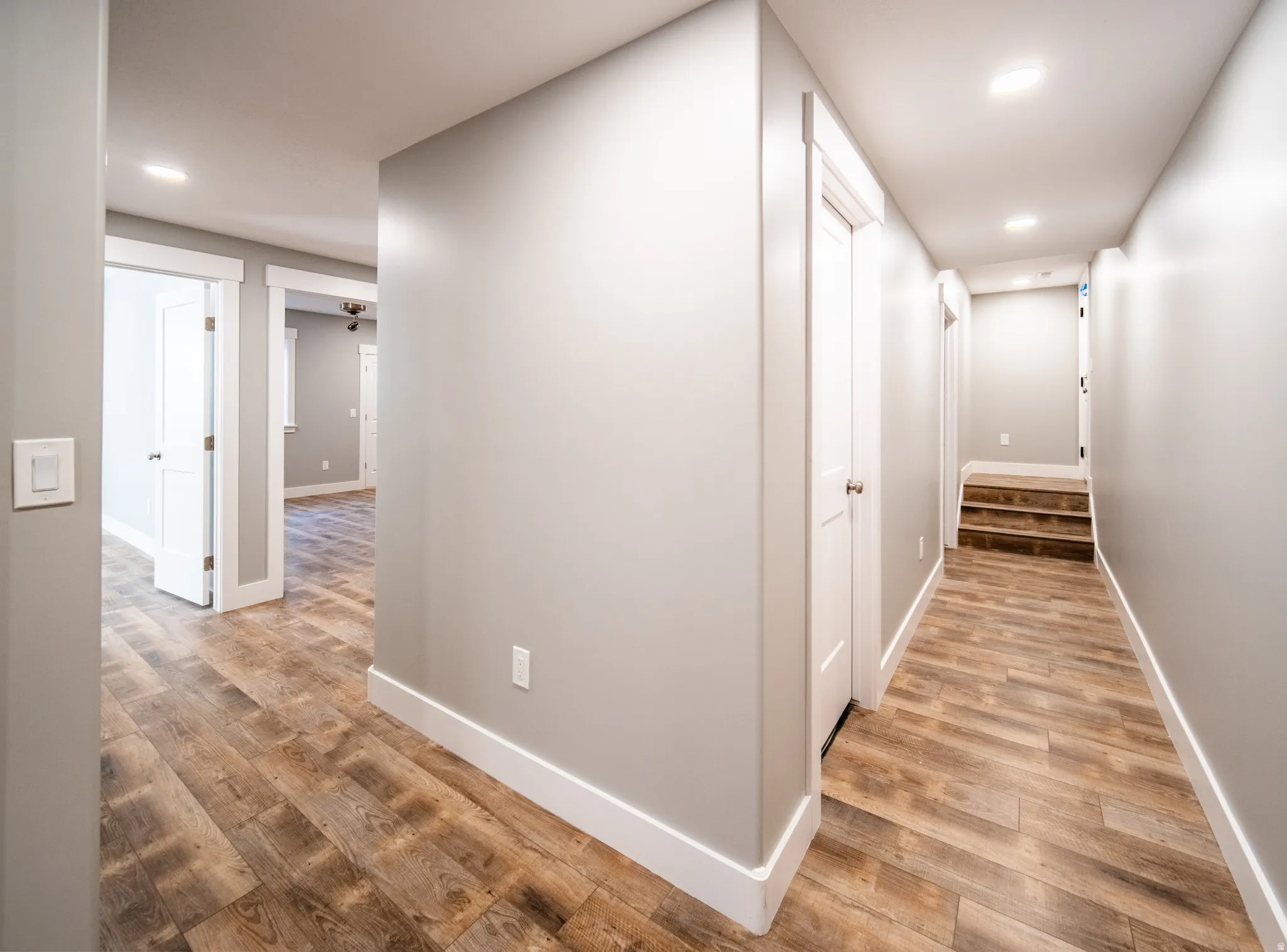 Hallway featuring light wood-type flooring and recessed lighting