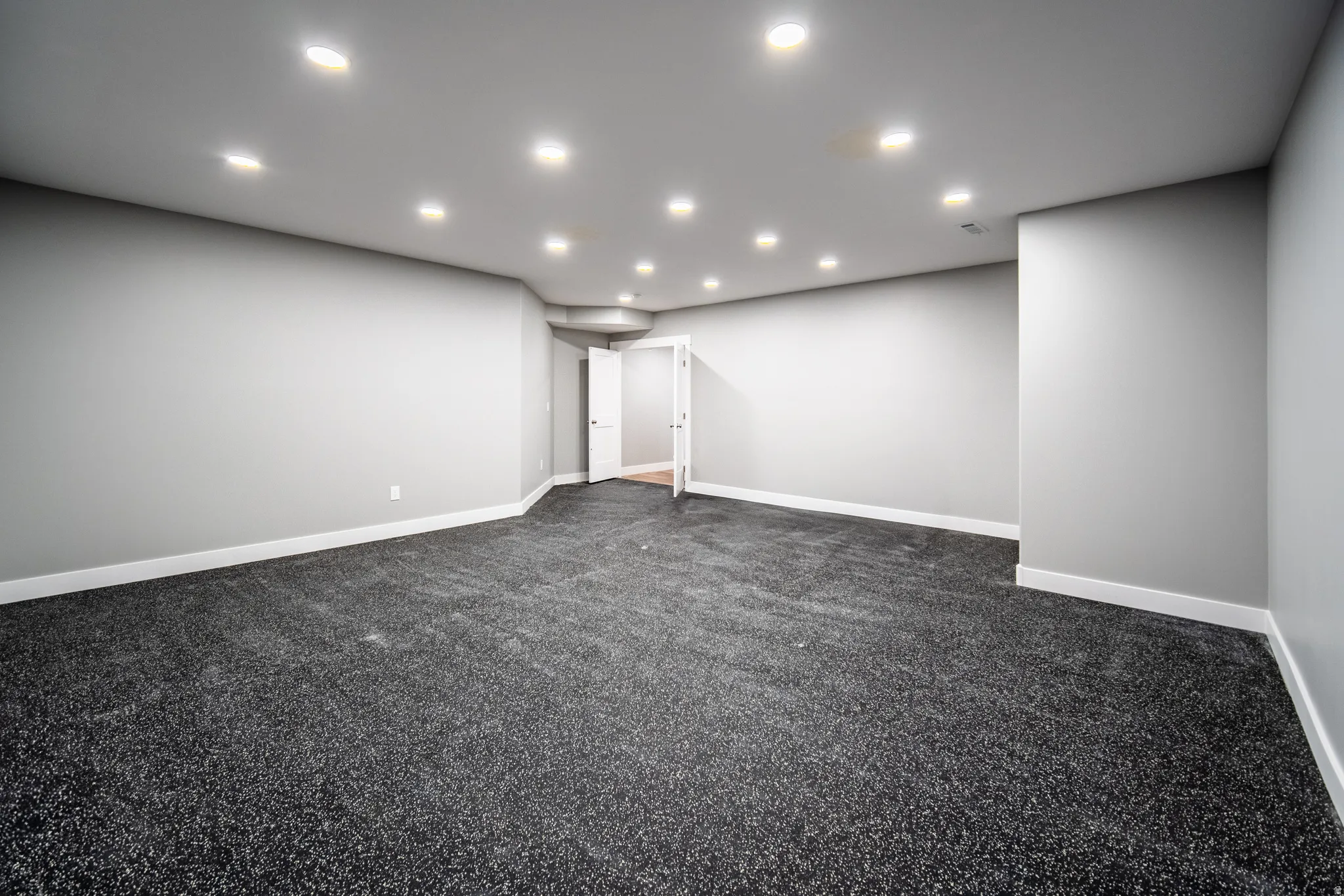 Home gym featuring Interlocking EVA foam flooring and space for equipment and racks.