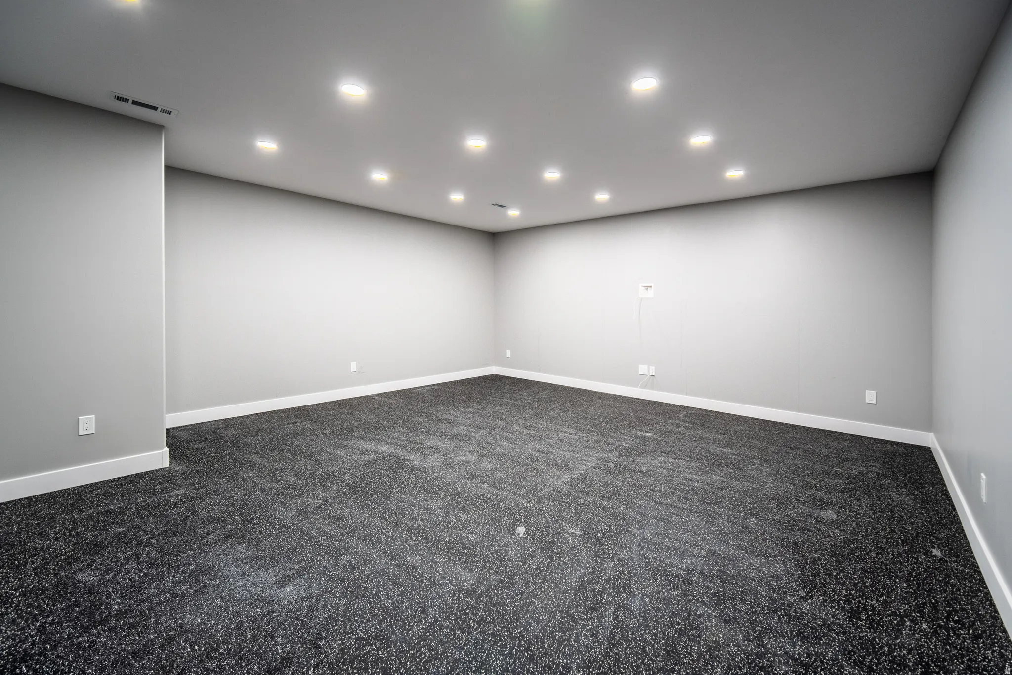 Home gym featuring Interlocking EVA foam flooring, space for equipment and racks, and designated TV location