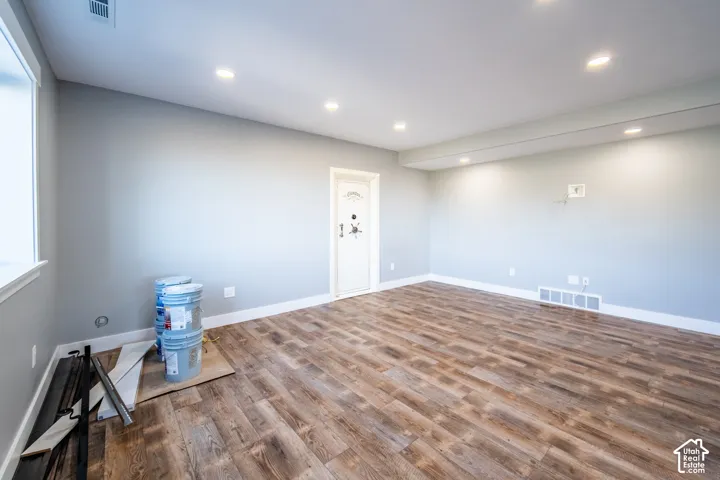 Basement living room with wood-style floors and recessed lighting
