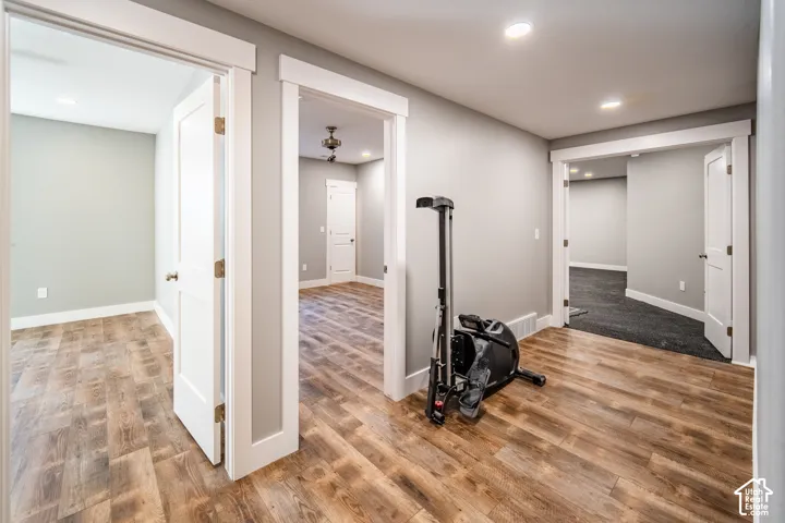 Hallway looking into ensuite bedroom, additional bedroom, and home gym.