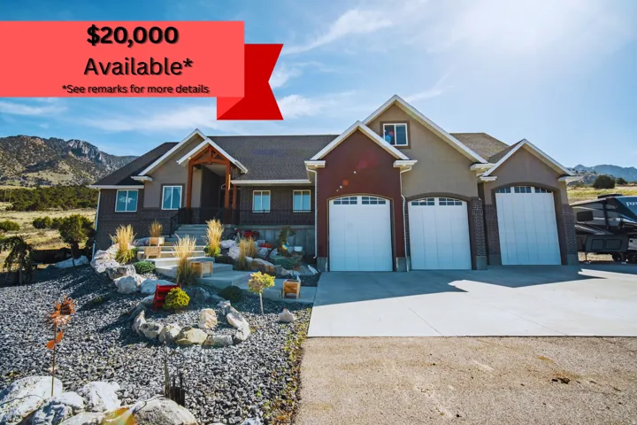 Multi-tone exterior with a prominent three-car garage featuring arched windows
