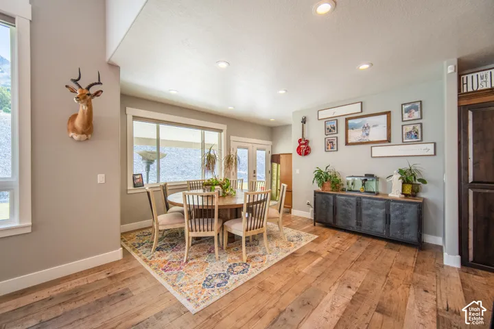 Dining area featuring recessed lighting, wood-style floors, and french doors