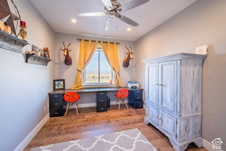 Home office with wood-style flooring, ceiling fan, and recessed lighting