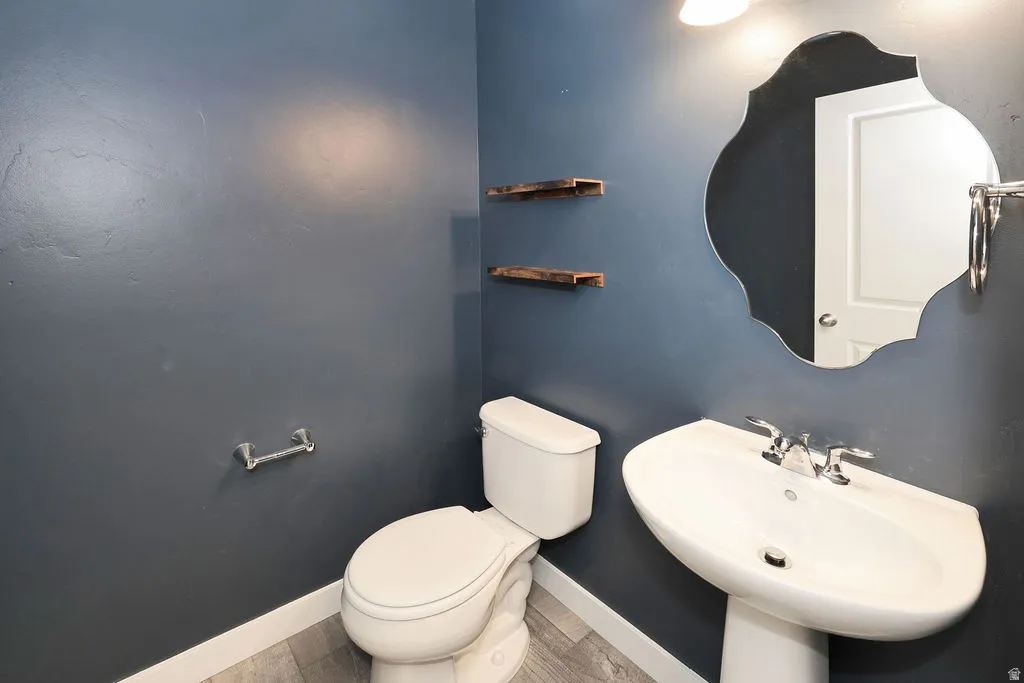 Half bath with toilet and baseboards