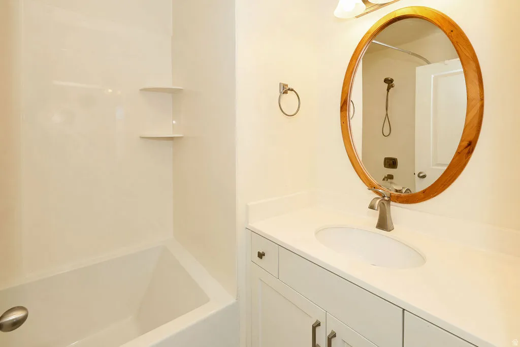Full bathroom featuring vanity and shower / washtub combination