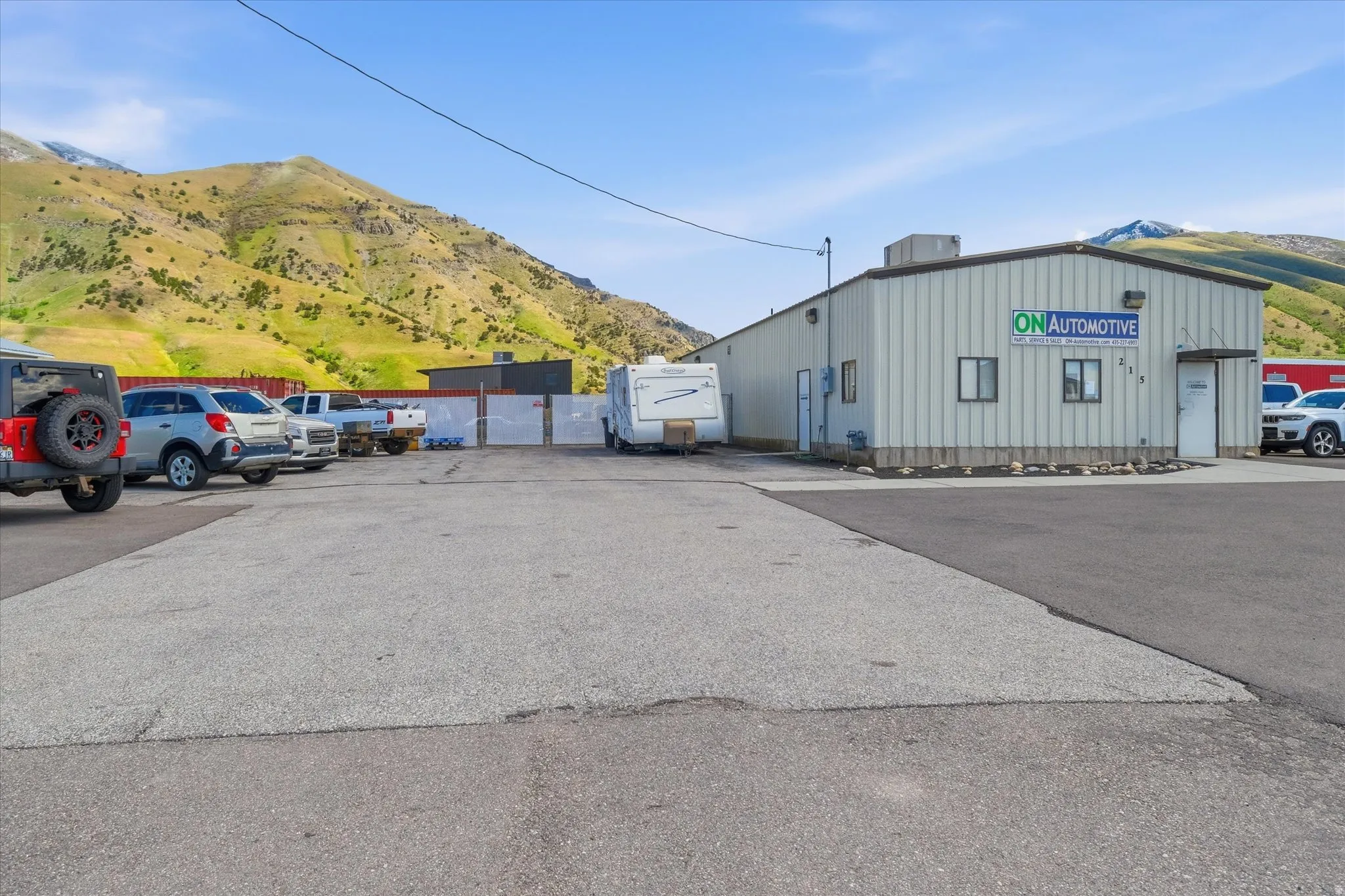 View of building exterior with a mountain view and uncovered parking