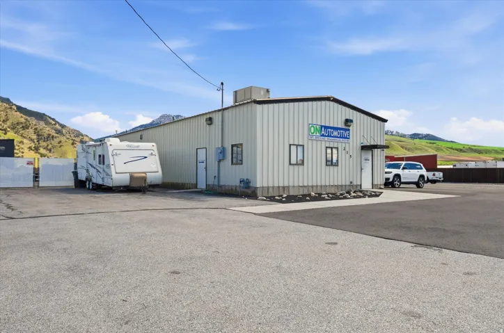 View of property featuring a mountain view and uncovered parking