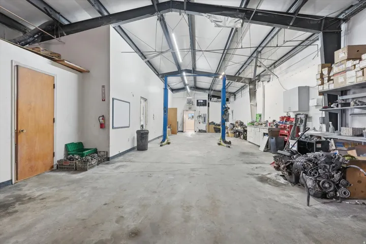 Miscellaneous room featuring a high ceiling and a garage