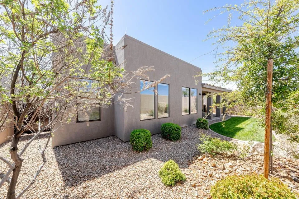 View of side of home with stucco siding and a patio