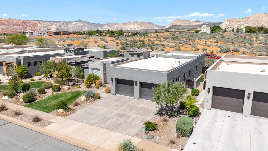 View of front of home featuring a mountain view and concrete driveway