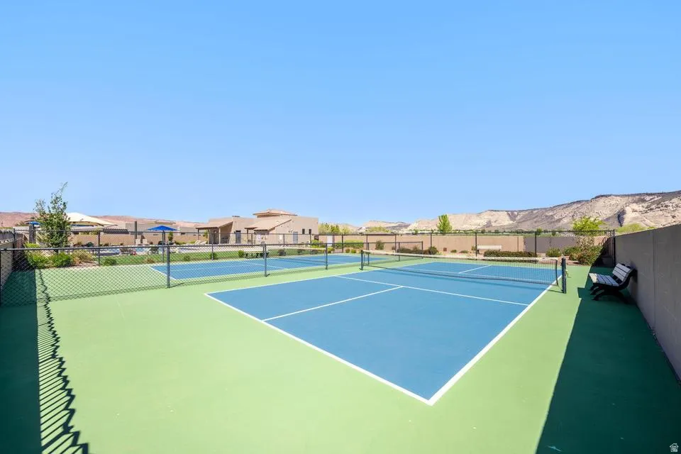 View of tennis court featuring a residential view
